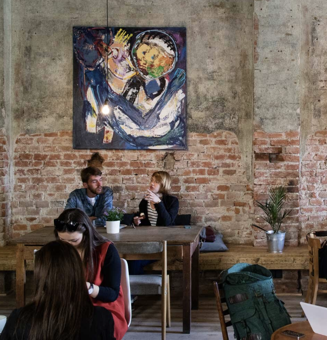 A barista pouring coffee in a café
